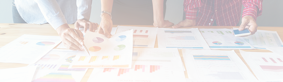 Trio of people looking over charts and spreadsheets